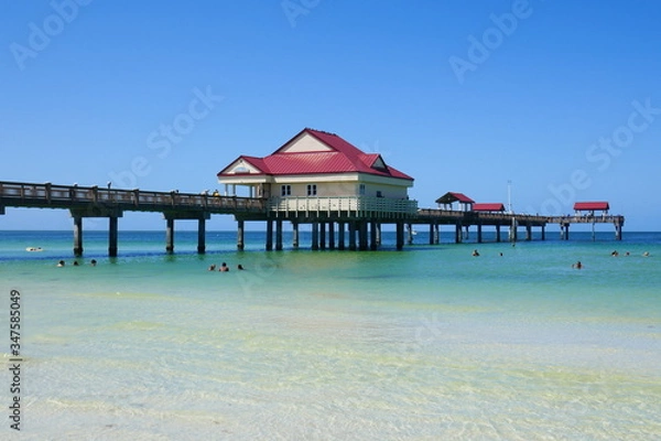 Fototapeta Pier over clean Blue Ocean water 