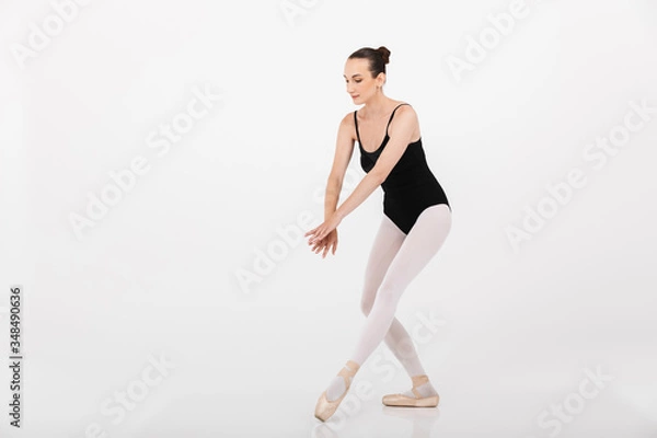 Fototapeta Image of caucasian woman ballerina practicing and dancing gracefully