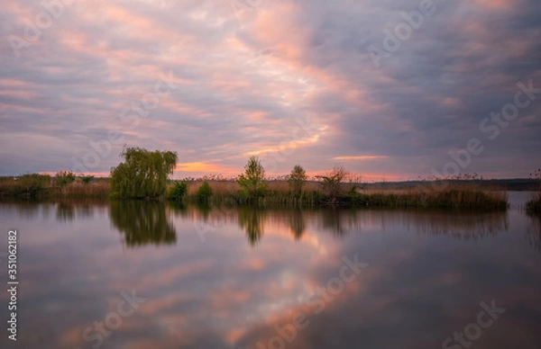 Fototapeta Long exposure sunset view on Ivano-Frankove (Yaniv), Yanivskyi Stav Lake and forest. Roztochia Biosphere Reserve, Lviv district, Ukraine. May 2020