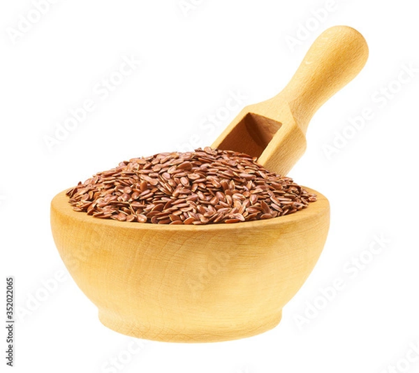 Fototapeta flaxseed in a wooden bowl with a scoop isolated on a white background.