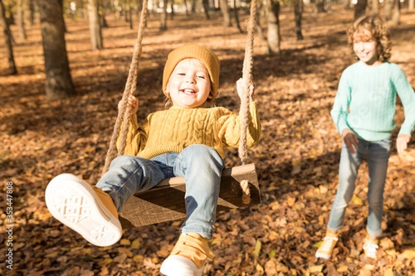 Fototapeta Happy children having fun outdoor in autumn park