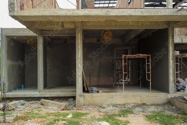 Fototapeta Perspective house under construction with clear blue sky background