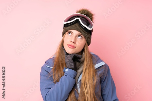 Fototapeta Skier teenager girl with snowboarding glasses over isolated pink background thinking an idea