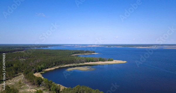 Fototapeta Aerial view of the coniferous forest and lake