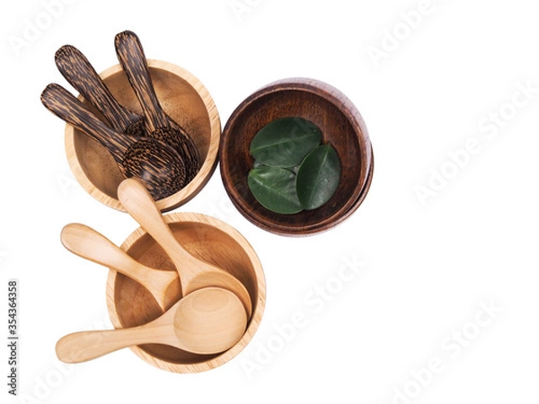 Fototapeta Top view set of wooden crockery cup bowl and spoon with green leaves