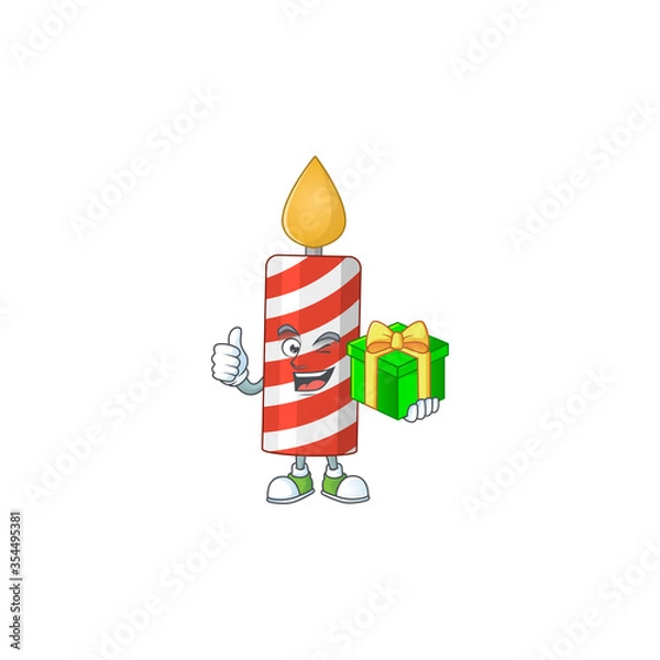 Fototapeta Happy smiley candle cartoon mascot design with a gift box