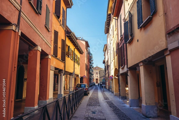 Fototapeta Narrow street with old residential buildings in historic part of Bologna city, Italy