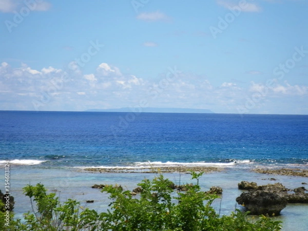 Fototapeta pati beach, on Pati Point is the easternmost point of Guam with the view of Rota island in the background