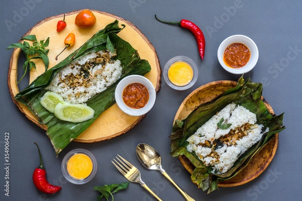 Fototapeta Organic roasted rice wrapped in banana leaves.