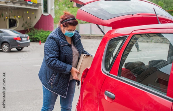 Fototapeta Social distance concept. Life people after quarantine. Middle aged plus size lady wear protective mask at street 