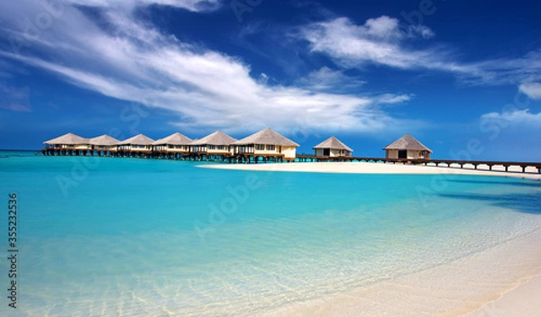 Fototapeta overwater bungalows on paradise lagoon of tropical island