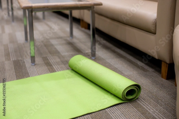 Fototapeta green yoga mat in the office