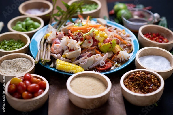 Fototapeta Raw rice flour in a wooden bowl with spices On a dark wood with natural light, focusing on the top of the noodles