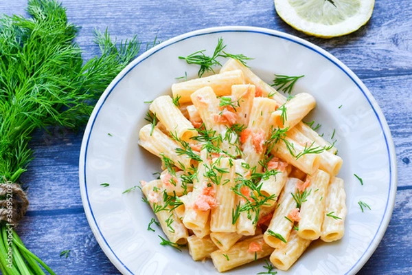 Fototapeta  Italian home made  macaroni pasta with smoked salmon , creamy sauce and fresh dill on wooden background