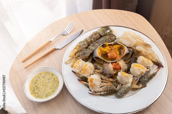 Fototapeta The dish of mix fresh seafood crab shrimp and Mantis shrimps, ready to eat. Wooden background