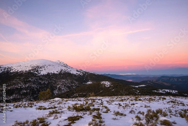 Fototapeta Sunset in mountains. Winter scenery. Beautiful pink and white sky, windy weather. Pink, purple and blue mild pastel colors. Navacerrada. Madrid