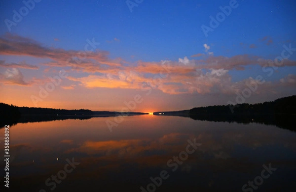 Fototapeta landscape with bright clouds and with reflections in the river before dawn