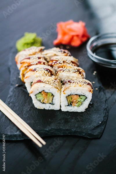 Fototapeta Sushi roll with eel on a slate plate