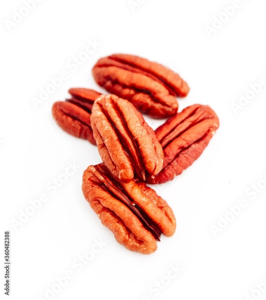 Fototapeta A group of raw pecan nuts, isolated on white background.