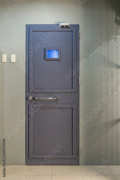 Fototapeta Image of locked metal grey door with window of lab in lost room.