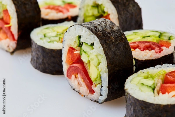 Fototapeta Vegetarian sushi rolls with cucumber, sweet pepper, avocado and lettuce on a white background