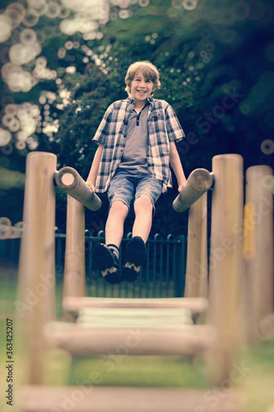 Fototapeta Boy having fun at the playground