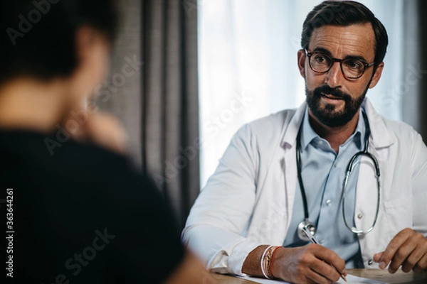 Fototapeta portrait of a doctor during a patient consultation