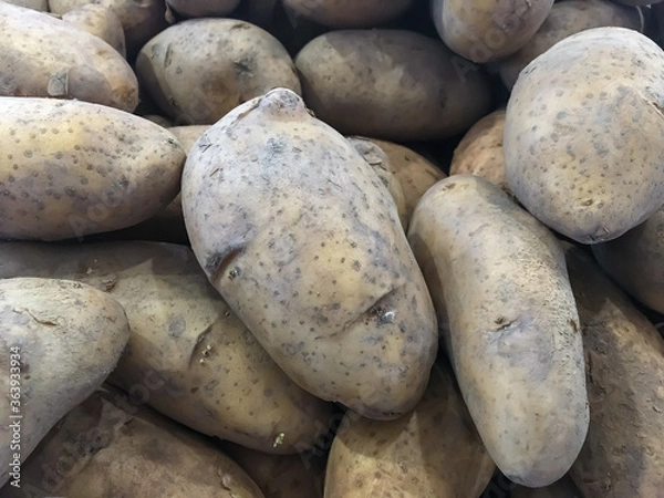 Fototapeta Brown potatoes placed as a background image