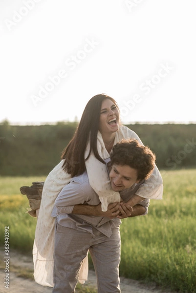 Obraz Young lovely couple. Man holds girlfriend. Soft selective focus.