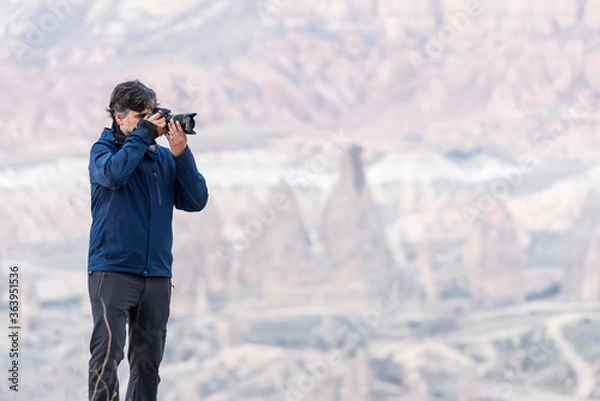 Fototapeta Photographer shooting picturesque hills