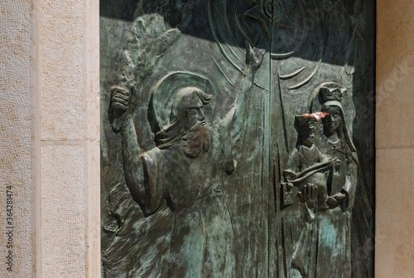 Obraz The religious bas-relief on the main entrance door of the Stella Maris Monastery which is located on Mount Carmel in Haifa city in northern Israel