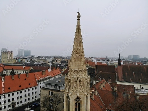 Fototapeta Slovakia, Bratislava. Historical old city centre. Aerial view from above, created by drone. Foggy day town landscape, travel photography. Town Hall tower