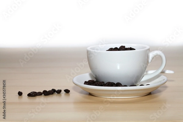 Fototapeta Coffee beans with coffee cup on wooden board