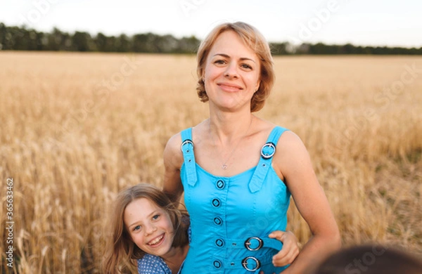 Fototapeta mother and daughter in wheat