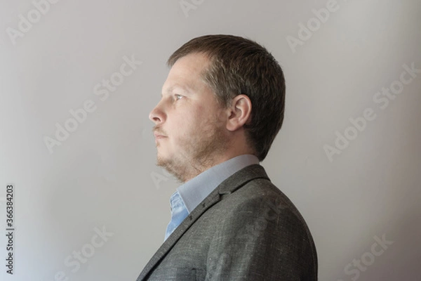 Fototapeta Man in suit and blue shirt.