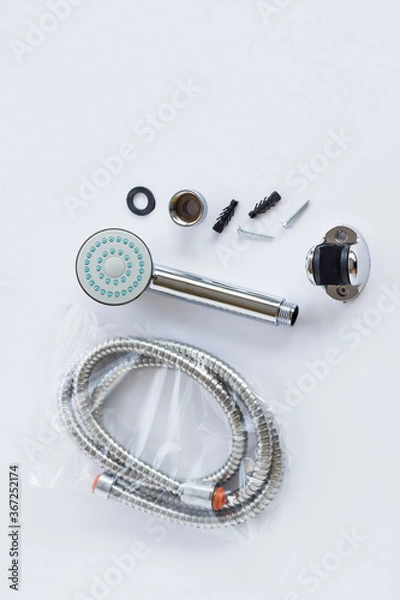 Fototapeta New,unused stainless steel of shower head and apparatus on white surface,top view