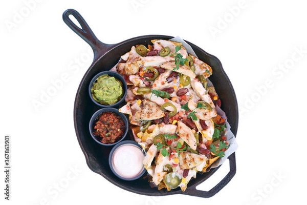 Fototapeta Grilled Chicken nachos with cream sauce served next to guacamole dip