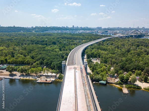 Fototapeta Construction of a bridge across the Dnieper river in Kiev. Aerial drone view.