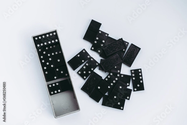 Fototapeta Dominoes lie on a white background