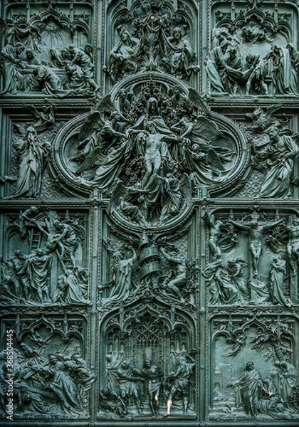 Fototapeta Detail of the beautiful bas-reliefs on the main bronze door of Milan Cathedral, famous tourist attraction