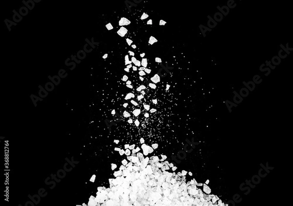 Fototapeta Close-up of macro crystals of sea salt or coarse salt isolated on black background