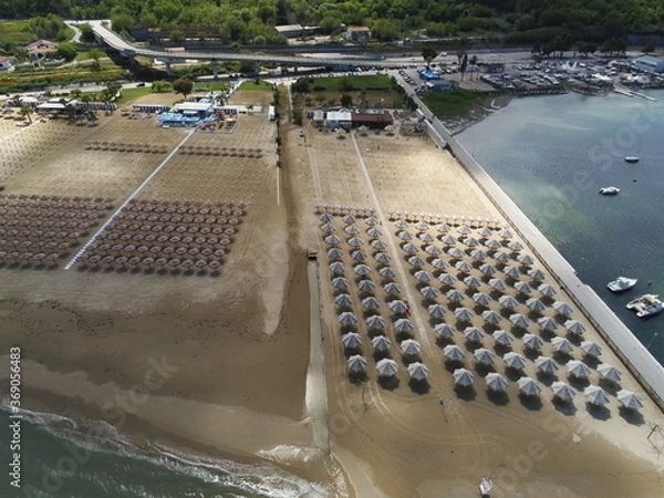 Fototapeta Beach with umbrellas but no people. Italian coast along adriatic sea