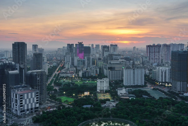 Fototapeta Cityscape of Hanoi skyline in Cau Giay district by Cau Giay park during sunset time in Hanoi city, Vietnam