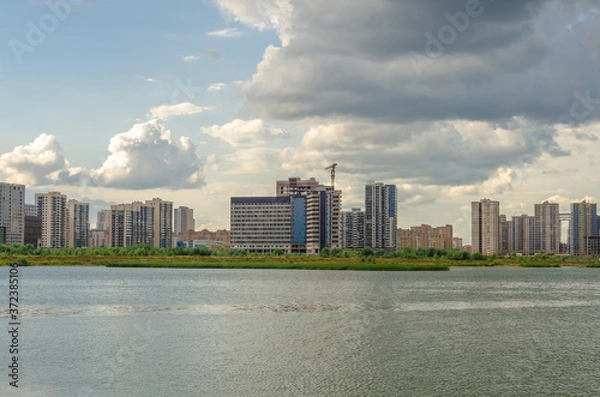 Fototapeta New residential areas are being built on the lake shore.