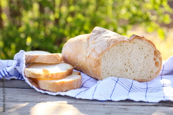 Fototapeta Bread on a wooden background close up