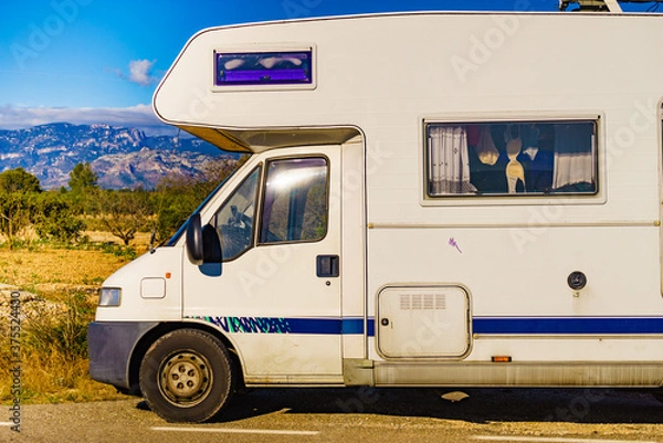 Fototapeta Camper against mountains nature