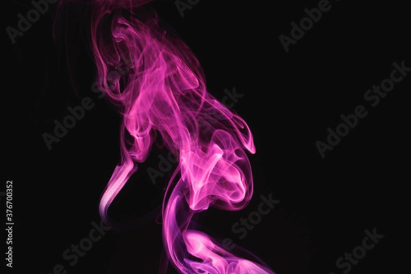 Fototapeta Purple smoke on a black background. Colored smoke. Incense stick smoke illuminated by purple light.