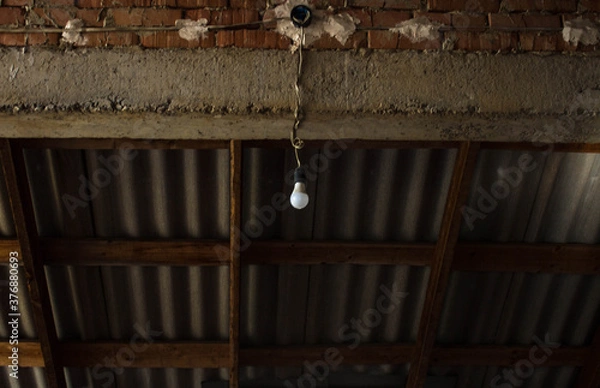 Fototapeta the old wall with bricks with a light bulb