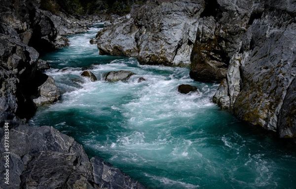 Fototapeta Beautiful emerald blue river flowing through the mountains