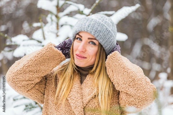 Fototapeta Attractive young woman in winter time outdoor. Snow, holidays and season concept.